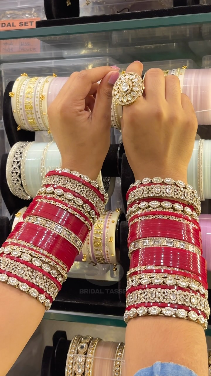 Bridal Tassel red chura with floral detailing, photographed on wrists